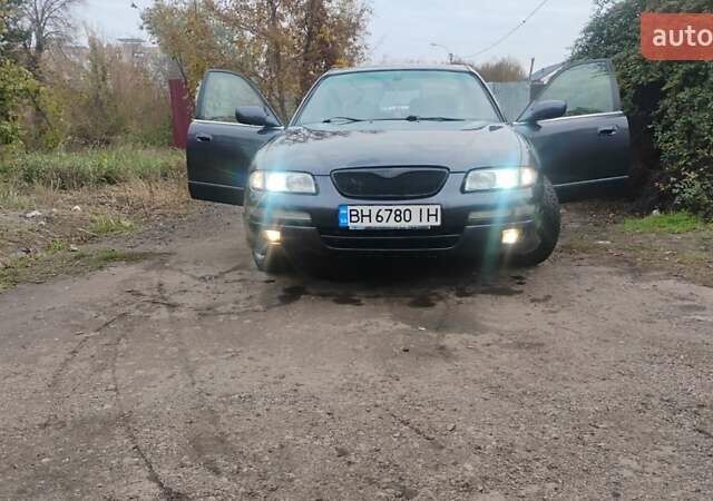 Серый Мазда Кседос 9, объемом двигателя 2.5 л и пробегом 341 тыс. км за 3500 $, фото 1 на Automoto.ua