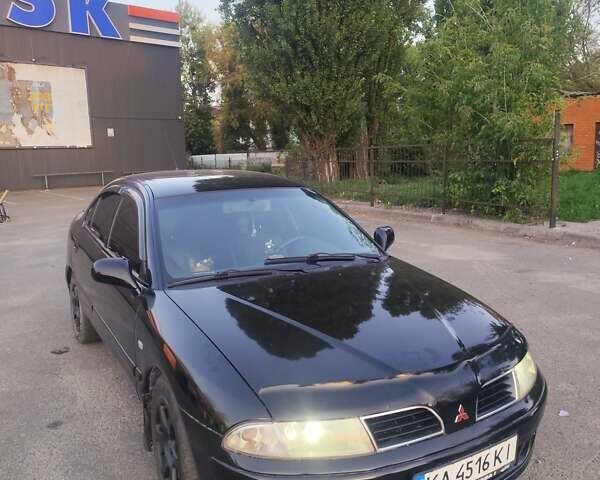 Черный Мицубиси Харизма, объемом двигателя 1.6 л и пробегом 330 тыс. км за 3200 $, фото 1 на Automoto.ua