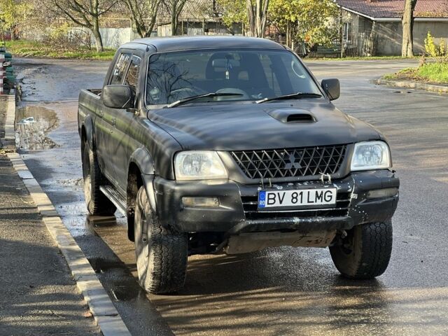 Черный Мицубиси Л 200, объемом двигателя 2.5 л и пробегом 270 тыс. км за 3500 $, фото 1 на Automoto.ua