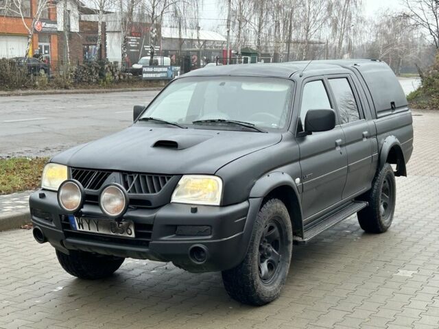 Черный Мицубиси Л 200, объемом двигателя 2.5 л и пробегом 250 тыс. км за 4250 $, фото 1 на Automoto.ua
