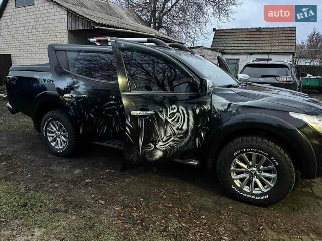 Черный Мицубиси Л 200, объемом двигателя 2.44 л и пробегом 160 тыс. км за 28000 $, фото 1 на Automoto.ua