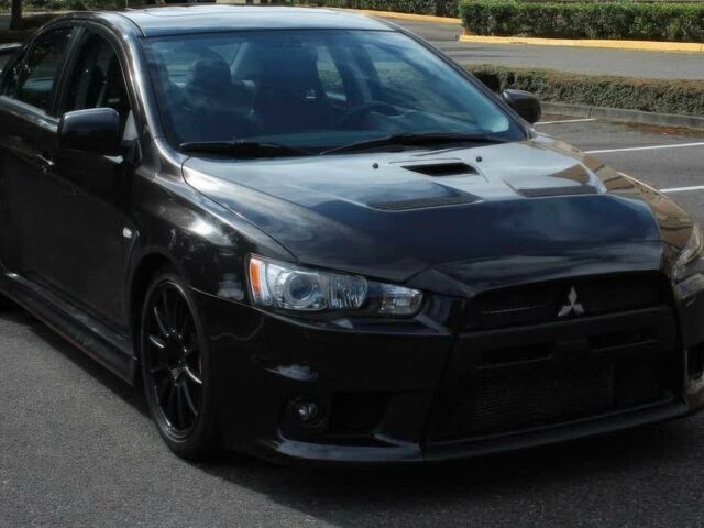 Черный Мицубиси Лансер Эволюшн, объемом двигателя 2 л и пробегом 88 тыс. км за 6400 $, фото 1 на Automoto.ua