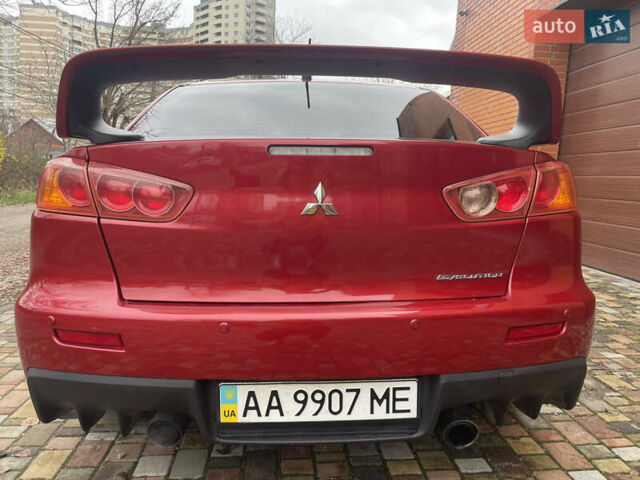 Красный Мицубиси Лансер Эволюшн, объемом двигателя 2 л и пробегом 110 тыс. км за 17000 $, фото 1 на Automoto.ua