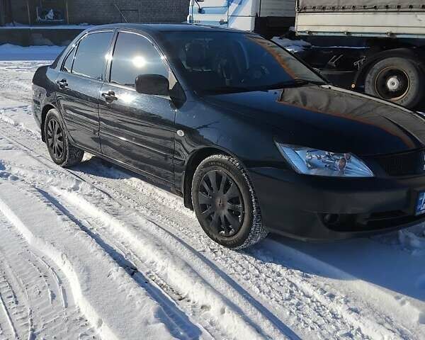 Черный Мицубиси Лансер, объемом двигателя 1.6 л и пробегом 180 тыс. км за 4400 $, фото 1 на Automoto.ua