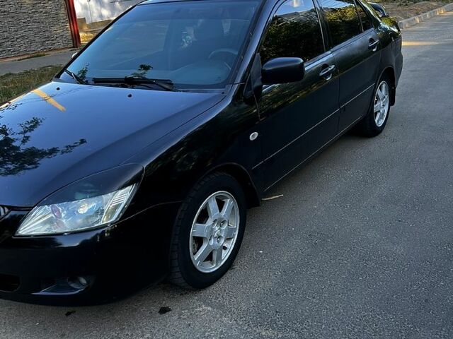 Черный Мицубиси Лансер, объемом двигателя 1.6 л и пробегом 263 тыс. км за 4200 $, фото 1 на Automoto.ua