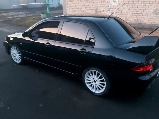 Черный Мицубиси Лансер, объемом двигателя 16 л и пробегом 220 тыс. км за 5000 $, фото 1 на Automoto.ua