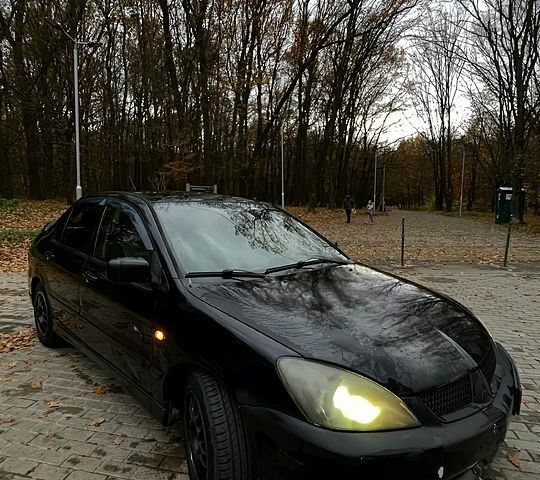 Черный Мицубиси Лансер, объемом двигателя 1.6 л и пробегом 200 тыс. км за 3000 $, фото 1 на Automoto.ua