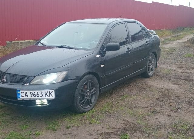 Черный Мицубиси Лансер, объемом двигателя 2 л и пробегом 270 тыс. км за 3200 $, фото 1 на Automoto.ua