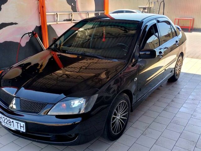 Черный Мицубиси Лансер, объемом двигателя 2 л и пробегом 253 тыс. км за 5500 $, фото 1 на Automoto.ua