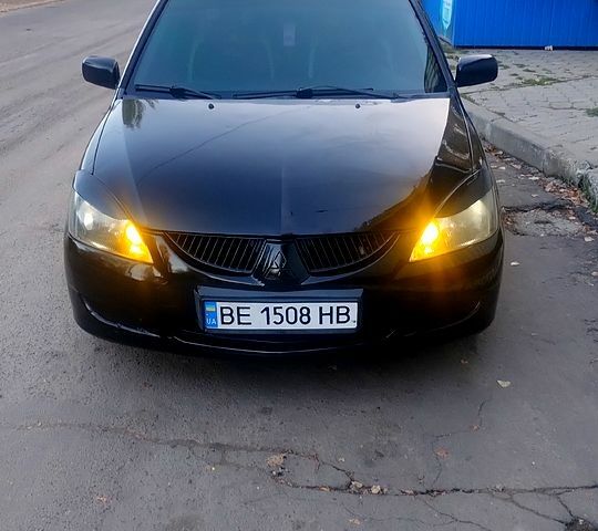 Черный Мицубиси Лансер, объемом двигателя 2 л и пробегом 250 тыс. км за 5800 $, фото 1 на Automoto.ua