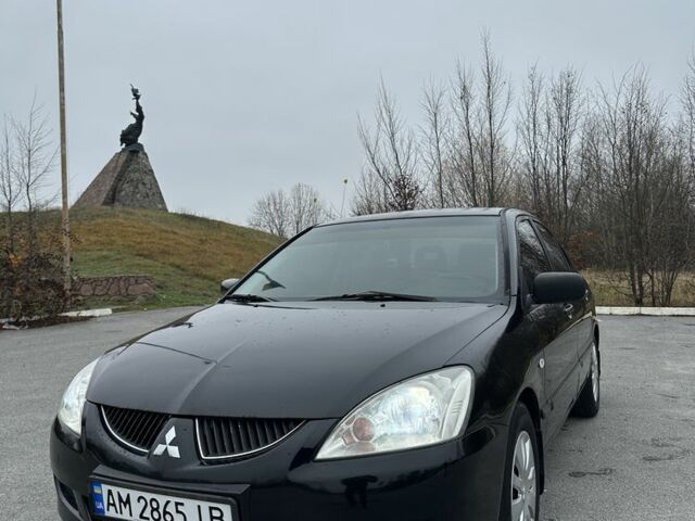 Черный Мицубиси Лансер, объемом двигателя 1.6 л и пробегом 200 тыс. км за 3500 $, фото 1 на Automoto.ua