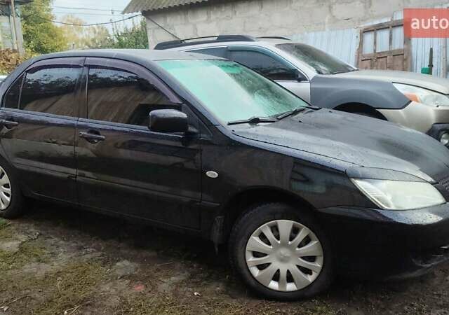 Чорний Міцубісі Lancer, об'ємом двигуна 1.58 л та пробігом 180 тис. км за 5000 $, фото 1 на Automoto.ua