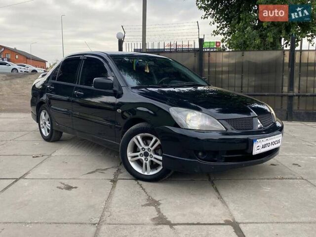 Черный Мицубиси Лансер, объемом двигателя 2 л и пробегом 248 тыс. км за 5190 $, фото 1 на Automoto.ua