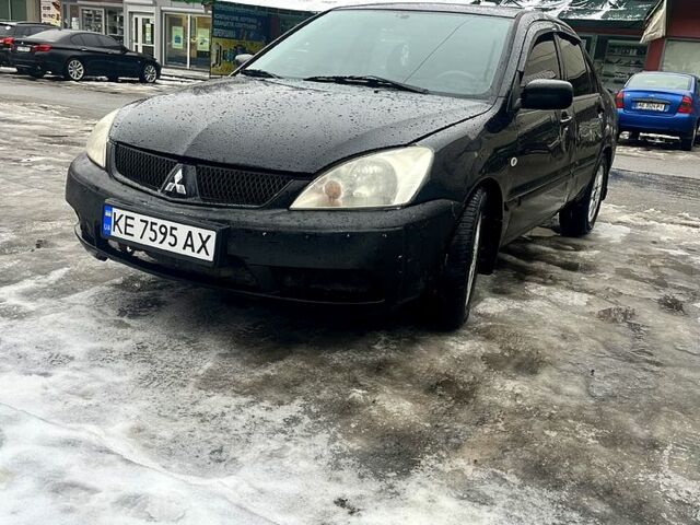 Черный Мицубиси Лансер, объемом двигателя 1.6 л и пробегом 300 тыс. км за 2500 $, фото 1 на Automoto.ua