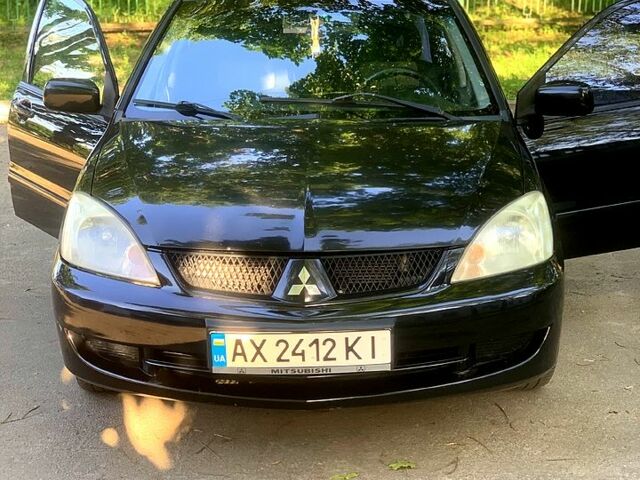 Черный Мицубиси Лансер, объемом двигателя 1.6 л и пробегом 285 тыс. км за 4400 $, фото 1 на Automoto.ua