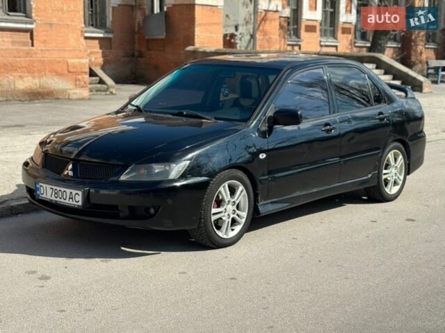 Черный Мицубиси Лансер, объемом двигателя 2 л и пробегом 265 тыс. км за 4100 $, фото 1 на Automoto.ua