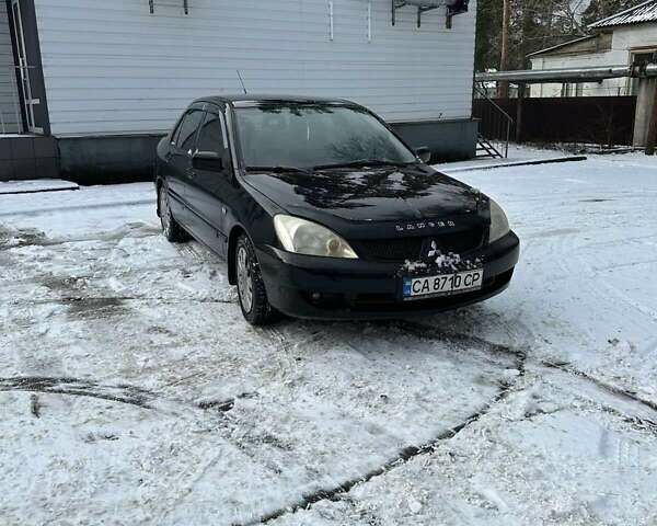 Черный Мицубиси Лансер, объемом двигателя 1.6 л и пробегом 257 тыс. км за 4000 $, фото 1 на Automoto.ua