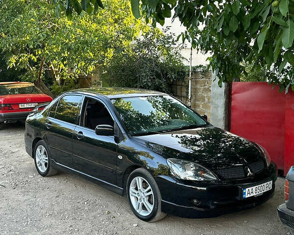 Черный Мицубиси Лансер, объемом двигателя 2 л и пробегом 255 тыс. км за 5000 $, фото 1 на Automoto.ua