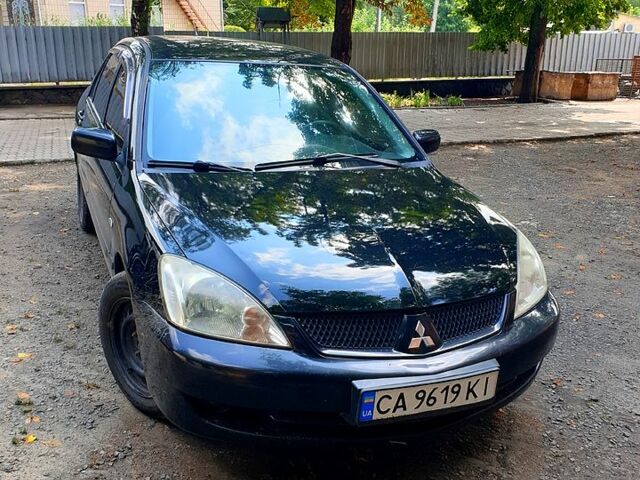 Черный Мицубиси Лансер, объемом двигателя 1.6 л и пробегом 230 тыс. км за 4200 $, фото 1 на Automoto.ua