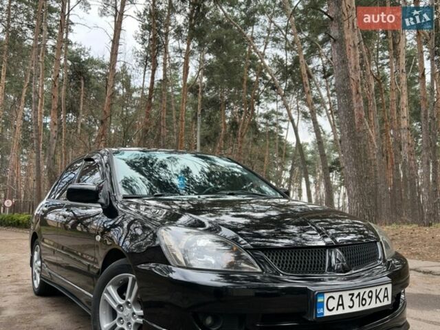 Черный Мицубиси Лансер, объемом двигателя 2 л и пробегом 243 тыс. км за 5400 $, фото 1 на Automoto.ua