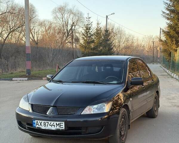 Черный Мицубиси Лансер, объемом двигателя 1.58 л и пробегом 247 тыс. км за 3300 $, фото 1 на Automoto.ua