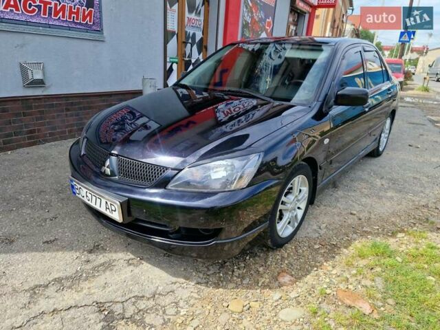 Черный Мицубиси Лансер, объемом двигателя 2 л и пробегом 168 тыс. км за 4999 $, фото 1 на Automoto.ua
