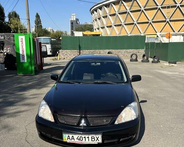 Черный Мицубиси Лансер, объемом двигателя 1.58 л и пробегом 171 тыс. км за 5000 $, фото 1 на Automoto.ua