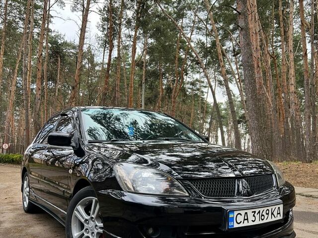 Черный Мицубиси Лансер, объемом двигателя 2 л и пробегом 243 тыс. км за 5400 $, фото 1 на Automoto.ua