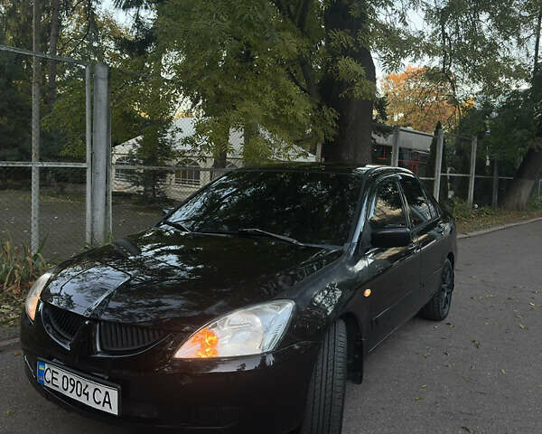 Черный Мицубиси Лансер, объемом двигателя 1.6 л и пробегом 233 тыс. км за 3650 $, фото 1 на Automoto.ua
