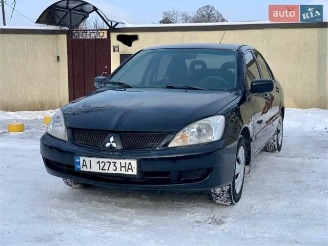 Чорний Міцубісі Lancer, об'ємом двигуна 1.58 л та пробігом 237 тис. км за 3850 $, фото 1 на Automoto.ua