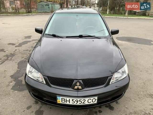 Черный Мицубиси Лансер, объемом двигателя 1.6 л и пробегом 164 тыс. км за 5200 $, фото 1 на Automoto.ua