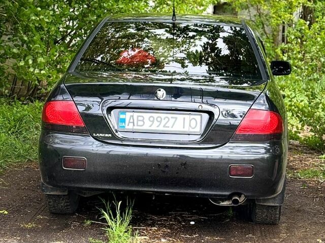 Черный Мицубиси Лансер, объемом двигателя 1.6 л и пробегом 249 тыс. км за 4444 $, фото 1 на Automoto.ua