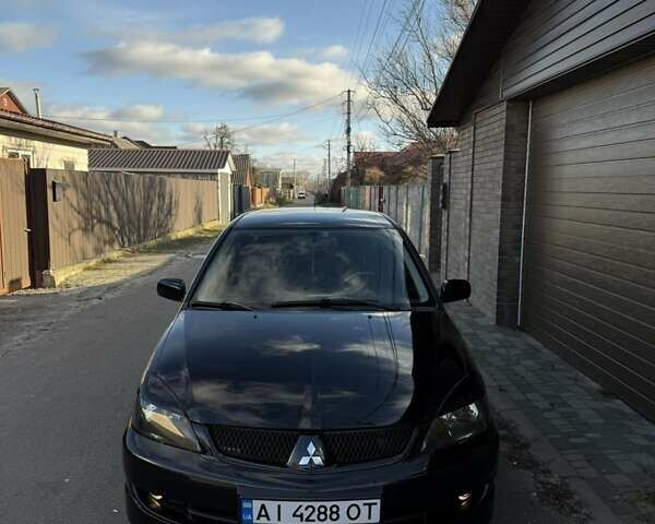 Черный Мицубиси Лансер, объемом двигателя 2 л и пробегом 220 тыс. км за 4600 $, фото 1 на Automoto.ua