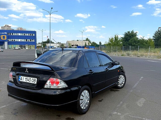 Черный Мицубиси Лансер, объемом двигателя 2 л и пробегом 250 тыс. км за 3850 $, фото 1 на Automoto.ua