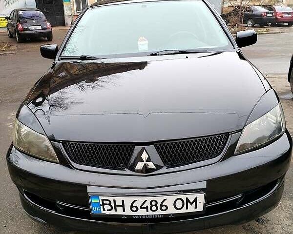 Черный Мицубиси Лансер, объемом двигателя 2 л и пробегом 190 тыс. км за 5000 $, фото 1 на Automoto.ua