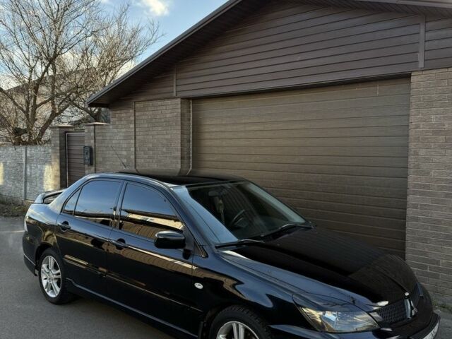 Черный Мицубиси Лансер, объемом двигателя 2 л и пробегом 220 тыс. км за 5250 $, фото 1 на Automoto.ua