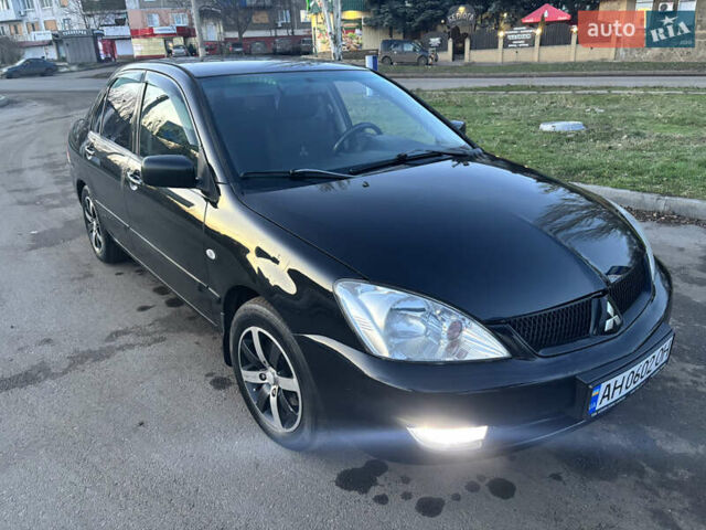 Черный Мицубиси Лансер, объемом двигателя 1.6 л и пробегом 315 тыс. км за 4000 $, фото 1 на Automoto.ua