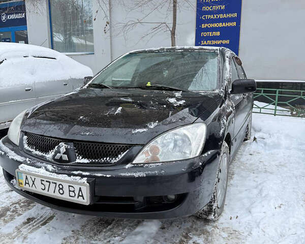 Черный Мицубиси Лансер, объемом двигателя 1.58 л и пробегом 265 тыс. км за 3550 $, фото 1 на Automoto.ua