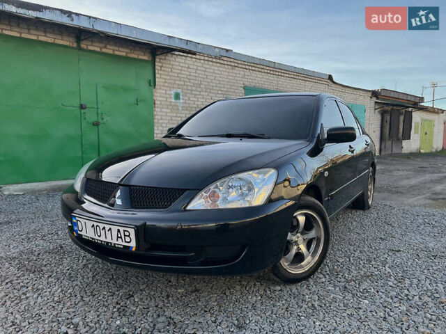 Черный Мицубиси Лансер, объемом двигателя 1.58 л и пробегом 156 тыс. км за 4599 $, фото 1 на Automoto.ua