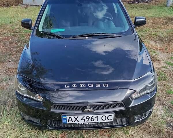 Черный Мицубиси Лансер, объемом двигателя 2 л и пробегом 200 тыс. км за 5900 $, фото 1 на Automoto.ua