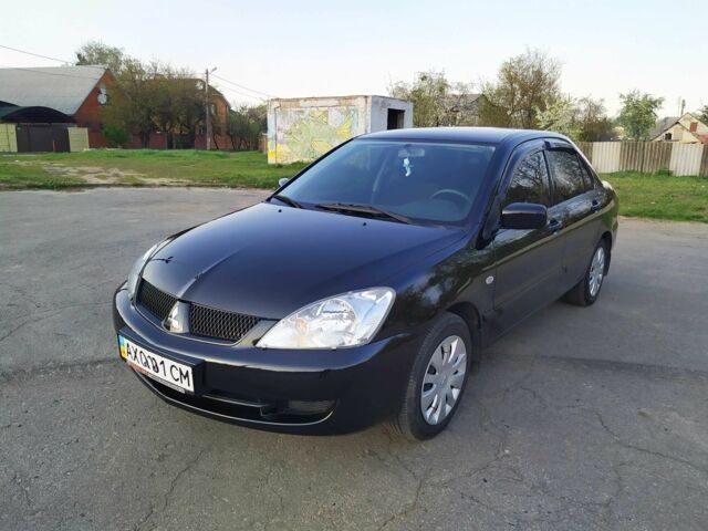 Черный Мицубиси Лансер, объемом двигателя 1.6 л и пробегом 32 тыс. км за 9000 $, фото 1 на Automoto.ua