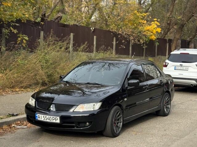 Черный Мицубиси Лансер, объемом двигателя 1.6 л и пробегом 211 тыс. км за 5600 $, фото 1 на Automoto.ua