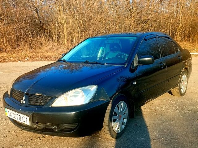Черный Мицубиси Лансер, объемом двигателя 1.6 л и пробегом 300 тыс. км за 3600 $, фото 1 на Automoto.ua