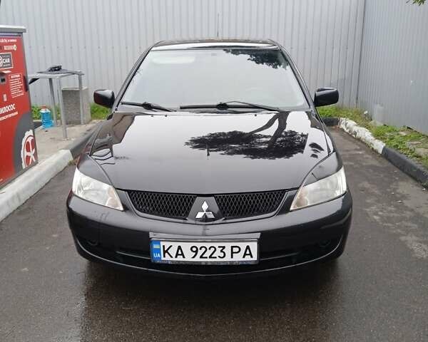 Черный Мицубиси Лансер, объемом двигателя 1.58 л и пробегом 180 тыс. км за 4500 $, фото 1 на Automoto.ua