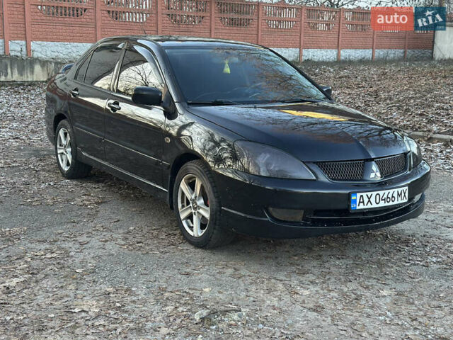 Черный Мицубиси Лансер, объемом двигателя 2 л и пробегом 300 тыс. км за 3999 $, фото 1 на Automoto.ua