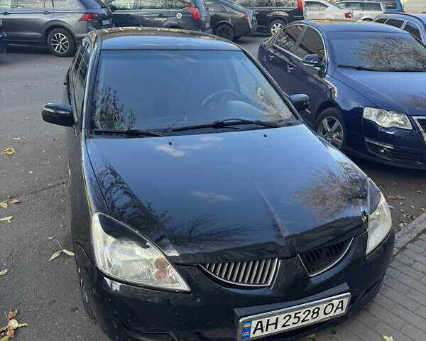 Чорний Міцубісі Lancer, об'ємом двигуна 1.58 л та пробігом 243 тис. км за 3800 $, фото 1 на Automoto.ua