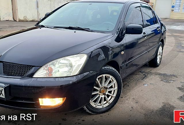 Черный Мицубиси Лансер, объемом двигателя 1.6 л и пробегом 115 тыс. км за 3600 $, фото 1 на Automoto.ua