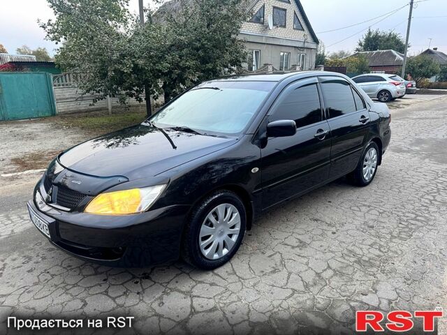 Черный Мицубиси Лансер, объемом двигателя 1.6 л и пробегом 240 тыс. км за 5000 $, фото 1 на Automoto.ua