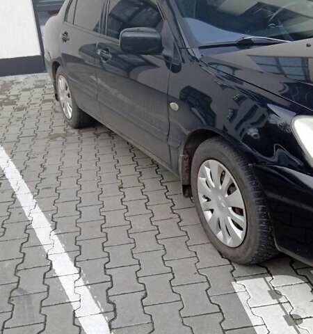 Черный Мицубиси Лансер, объемом двигателя 1.6 л и пробегом 223 тыс. км за 4300 $, фото 1 на Automoto.ua