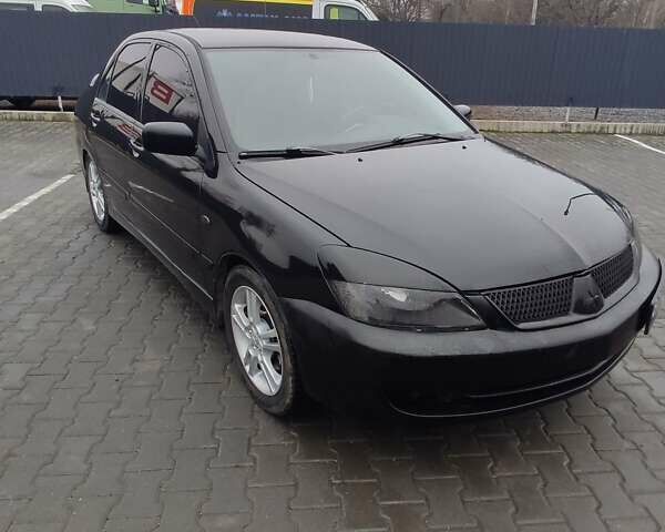 Чорний Міцубісі Lancer, об'ємом двигуна 2 л та пробігом 145 тис. км за 5000 $, фото 1 на Automoto.ua